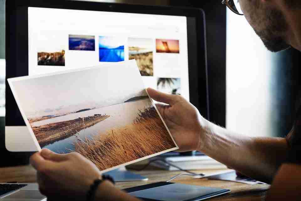 photographer looking at work, digital photographer looking at his photos on monitor, team building 