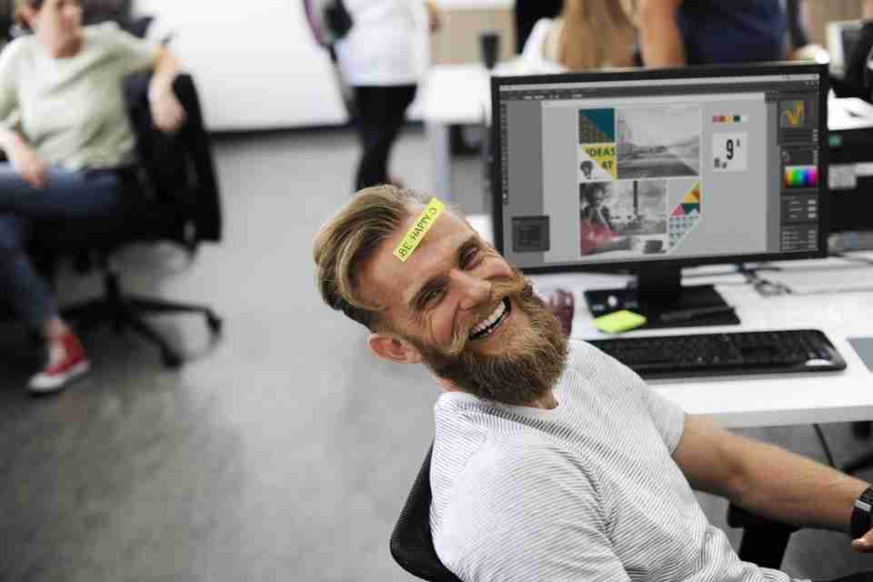 happy employee, mployee with sticker on forehead, laughing employee at work, team building